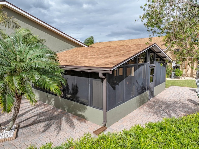 exterior space with a patio area and a sunroom