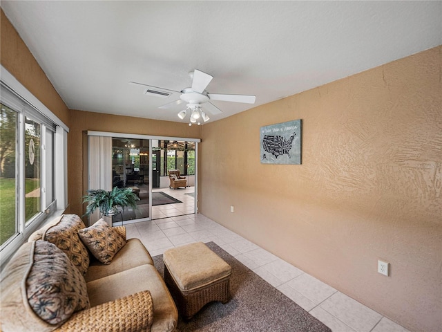 living room with light tile patterned floors and ceiling fan