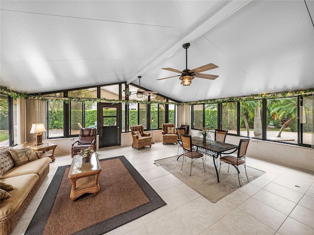 sunroom featuring ceiling fan and vaulted ceiling with beams