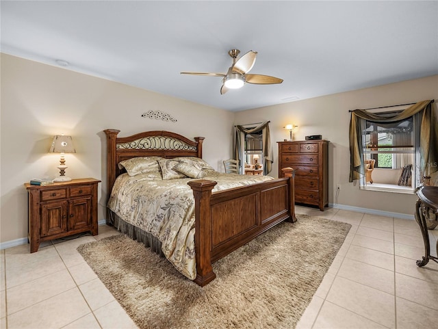 tiled bedroom featuring ceiling fan