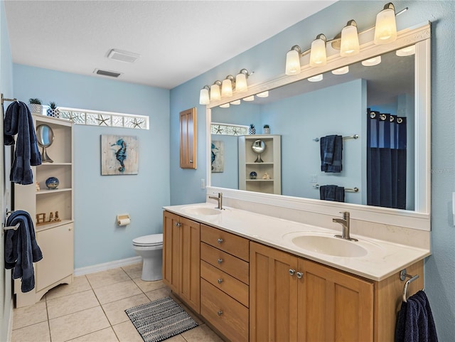 bathroom with vanity, tile patterned floors, and toilet