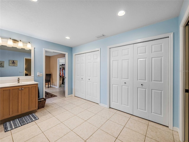 bathroom featuring tile patterned flooring and vanity