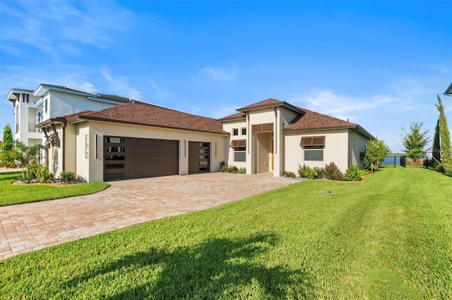 view of front of property featuring a garage and a front yard