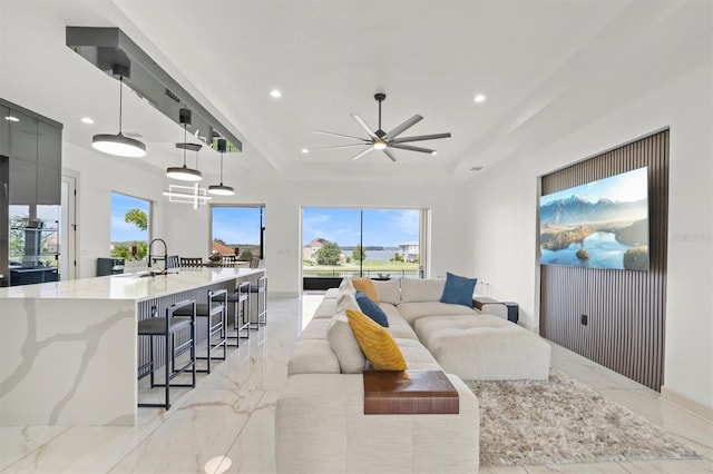 193 Stargrass Dr, Auburndale, FL 33823 - living room featuring light marble finish flooring, a tray ceiling, recessed lighting, and ceiling fan