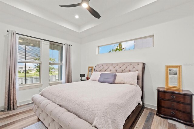 193 Stargrass Dr, Auburndale, FL 33823 - bedroom with wood finished floors, a raised ceiling, baseboards, a ceiling fan, and recessed lighting