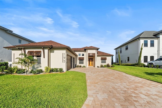193 Stargrass Dr, Auburndale, FL 33823 - view of front of property with a garage, a front yard, decorative driveway, and stucco siding
