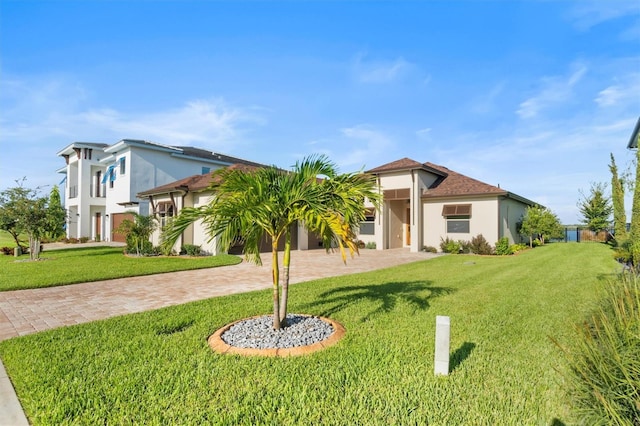 193 Stargrass Dr, Auburndale, FL 33823 - view of front of property with stucco siding, a front yard, and decorative driveway