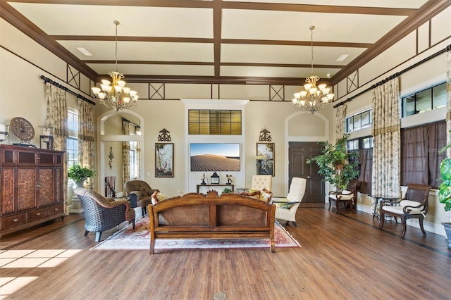 193 Stargrass Dr, Auburndale, FL 33823 - living area with a chandelier, a high ceiling, arched walkways, wood finished floors, and crown molding