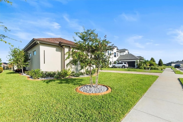 193 Stargrass Dr, Auburndale, FL 33823 - view of front facade featuring stucco siding, a front yard, and driveway