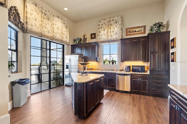 193 Stargrass Dr, Auburndale, FL 33823 - kitchen with appliances with stainless steel finishes, a towering ceiling, dark wood-style flooring, dark brown cabinets, and recessed lighting