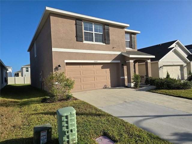 view of front of house featuring a garage and a front lawn