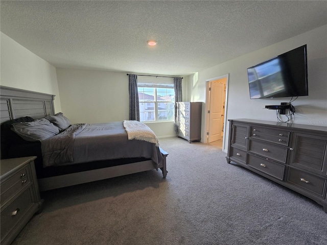 bedroom with a textured ceiling and light carpet