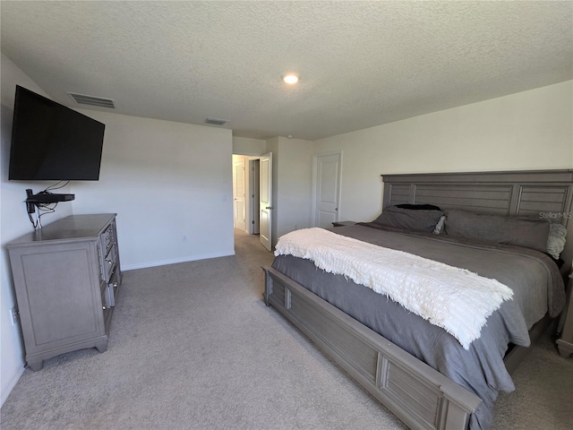 carpeted bedroom featuring a textured ceiling