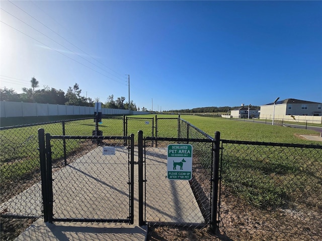 view of gate with a yard