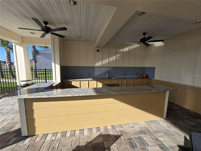 view of patio / terrace with ceiling fan and sink