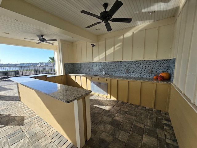 view of patio / terrace featuring ceiling fan and sink