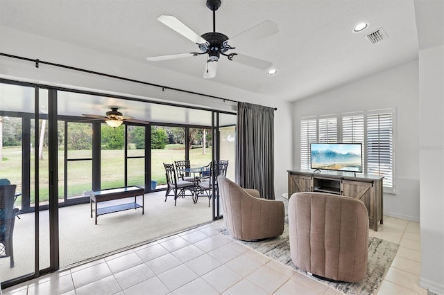 tiled living room featuring a wealth of natural light, lofted ceiling, and ceiling fan