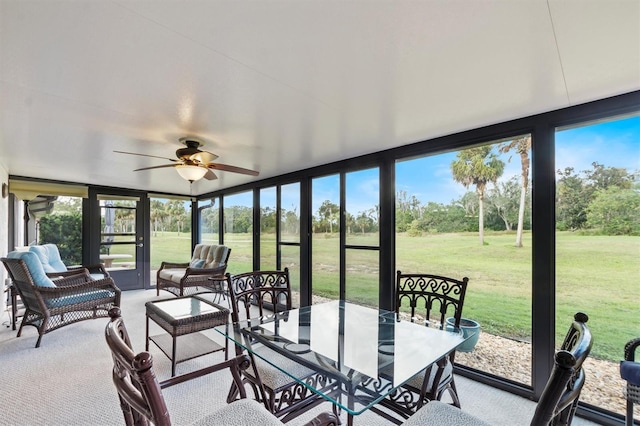 sunroom / solarium featuring ceiling fan