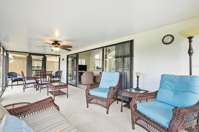 sunroom / solarium featuring ceiling fan