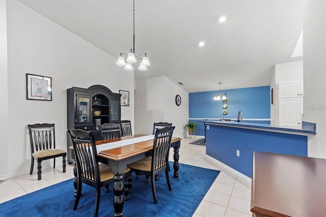 tiled dining room featuring sink and a chandelier