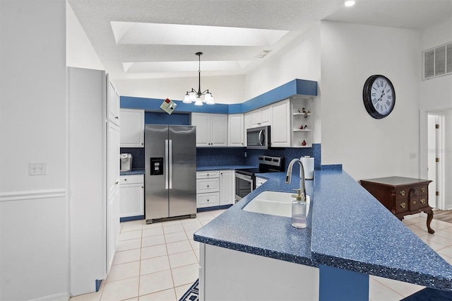 kitchen featuring white cabinetry, pendant lighting, decorative backsplash, kitchen peninsula, and stainless steel appliances