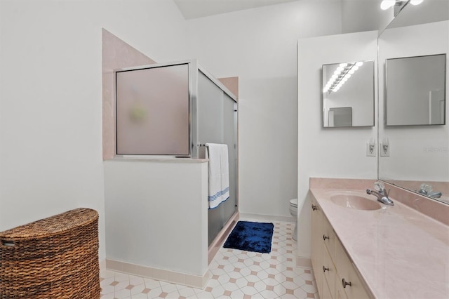 bathroom featuring vanity, toilet, and walk in shower