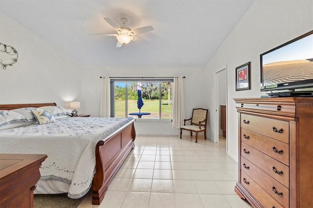 bedroom featuring ceiling fan, light tile patterned floors, and lofted ceiling