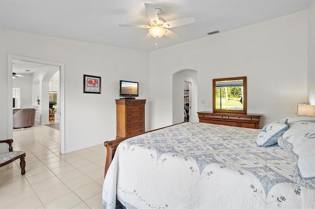 tiled bedroom featuring ceiling fan