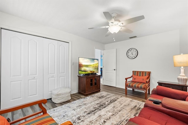 living room with ceiling fan and wood-type flooring