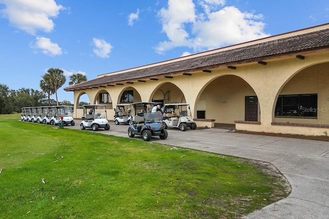 view of vehicle parking with a yard