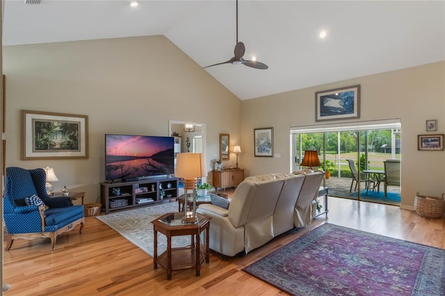 living room featuring high vaulted ceiling, light hardwood / wood-style flooring, and ceiling fan