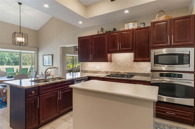 kitchen with stainless steel appliances, a center island, vaulted ceiling, hanging light fixtures, and sink