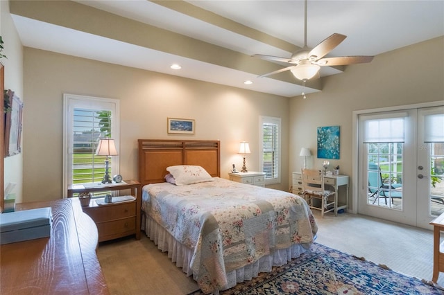 carpeted bedroom with multiple windows, ceiling fan, and access to exterior