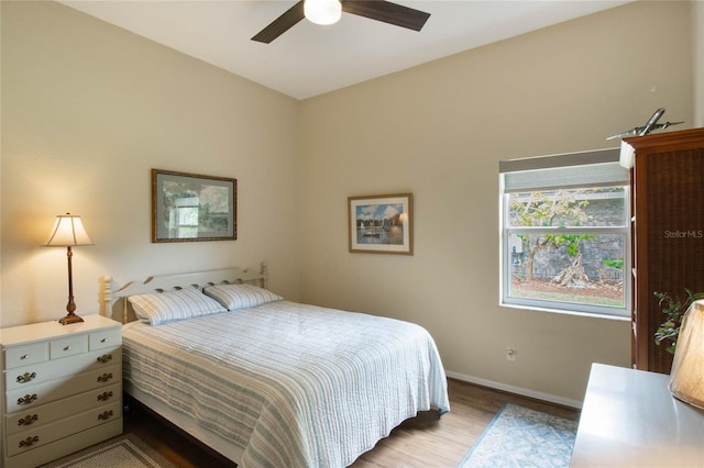 bedroom with ceiling fan and light hardwood / wood-style flooring