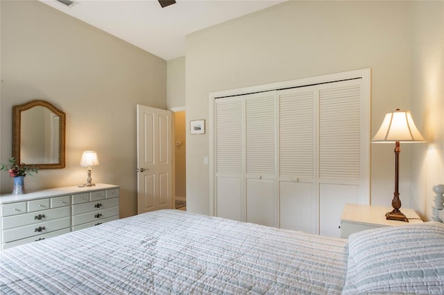 bedroom featuring ceiling fan, a closet, and lofted ceiling