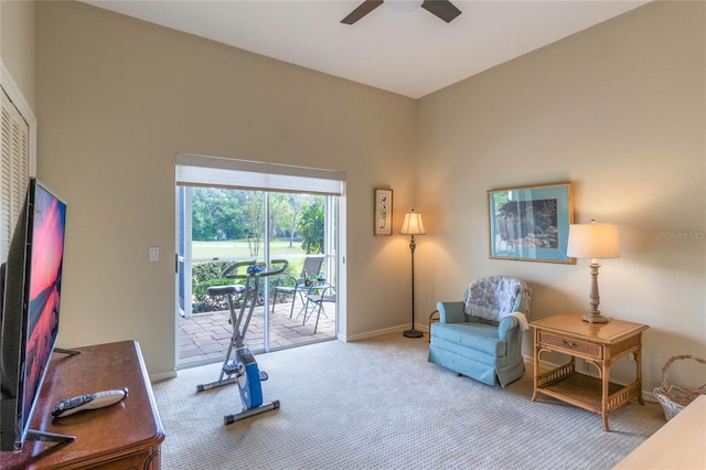 interior space featuring light colored carpet and ceiling fan