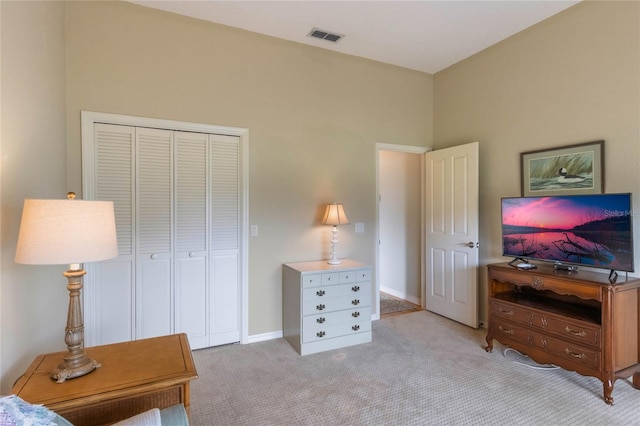 bedroom with light colored carpet and a closet