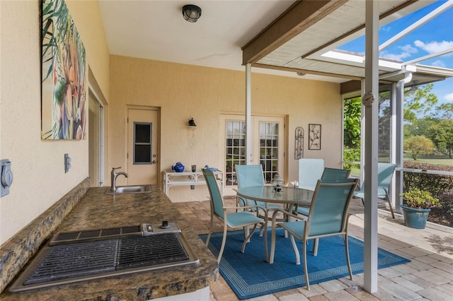 sunroom featuring a skylight and sink