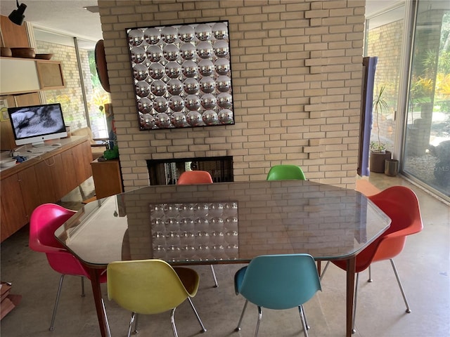 dining space with brick wall