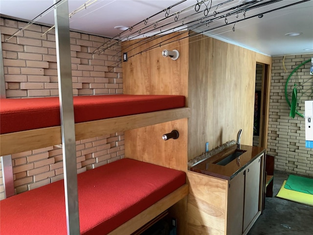 interior space with brick wall and sink