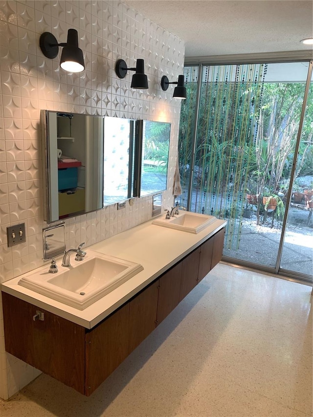 bathroom featuring tasteful backsplash, vanity, and a textured ceiling