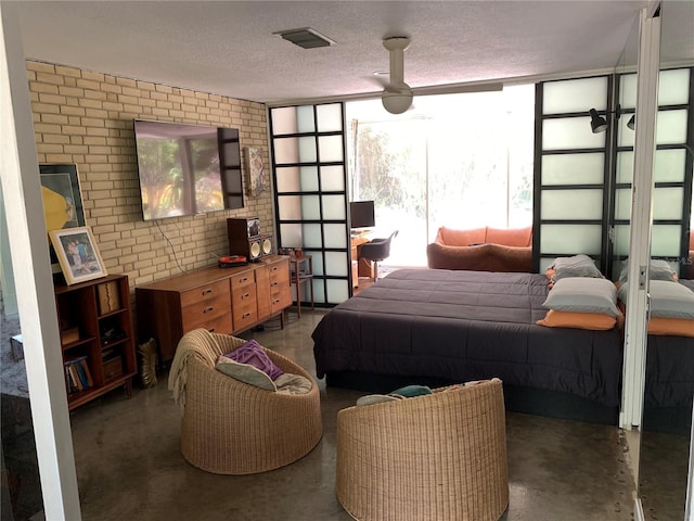 bedroom featuring ceiling fan and a textured ceiling