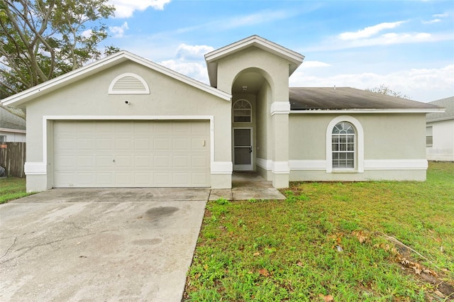 view of front of house with a garage and a front yard