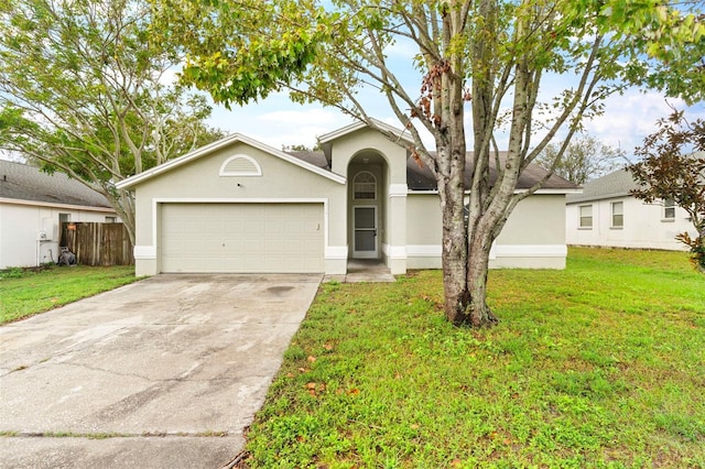 view of front of property with a garage and a front yard