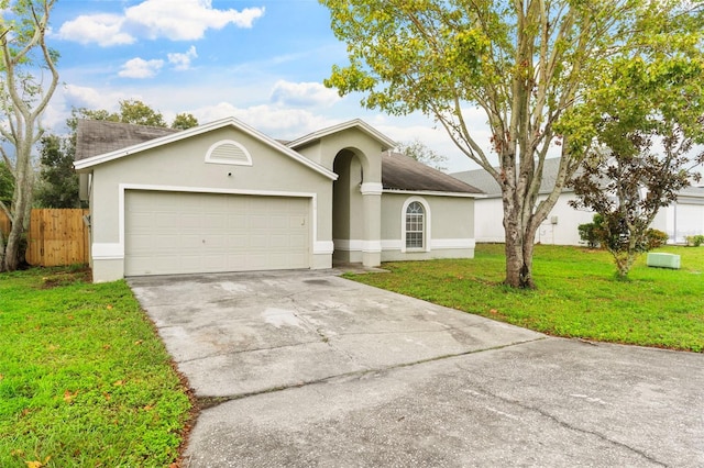 view of front of house with a front yard and a garage