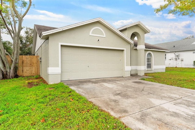 ranch-style home featuring a garage and a front yard