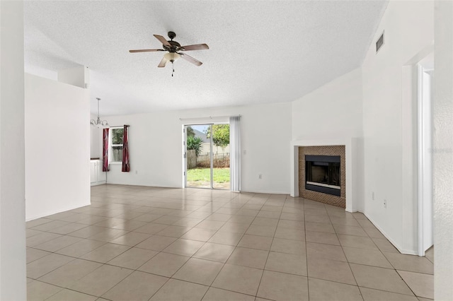 unfurnished living room featuring a textured ceiling, light tile patterned floors, high vaulted ceiling, ceiling fan, and a fireplace