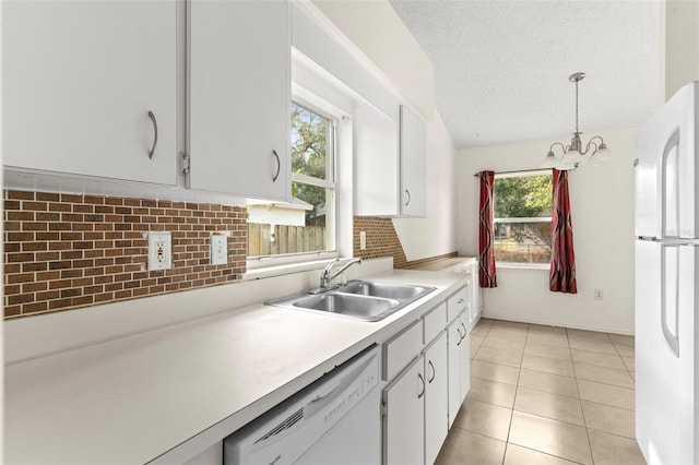 kitchen with white cabinetry, a textured ceiling, hanging light fixtures, sink, and white appliances