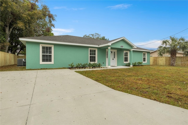 ranch-style home with central air condition unit and a front lawn