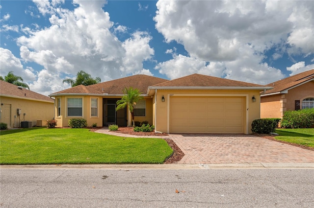 ranch-style home featuring a front yard and a garage